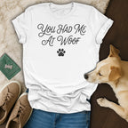 White t-shirt with "You HAD Me At Woof" text and a paw print.