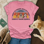 Pink t-shirt with three dogs, "Guarded the Pharaohs. Sailed with Vikings. Currently Chasing Squirrels."