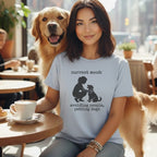 Woman with golden retriever dog and coffee, wearing t-shirt with text.