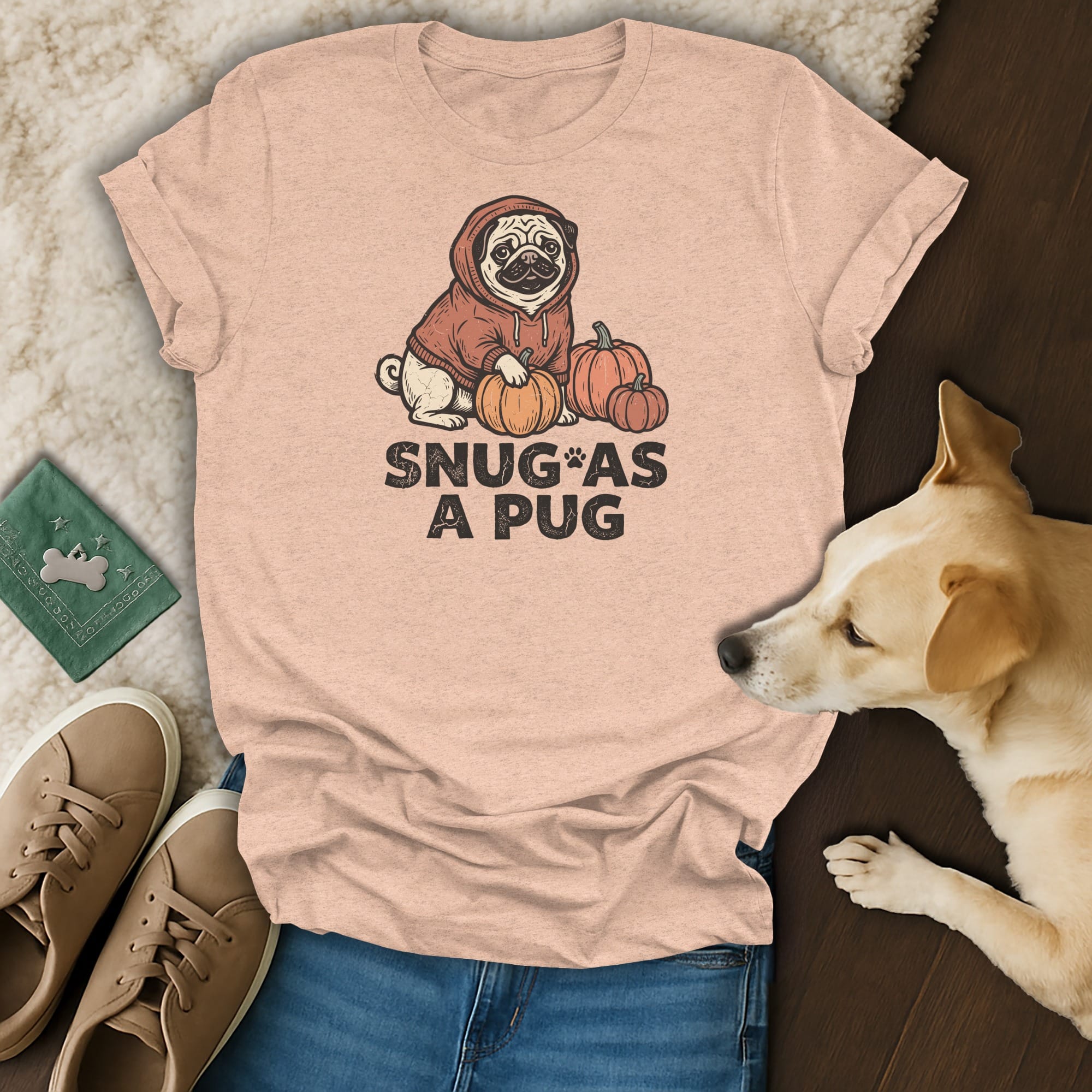 Light pink t-shirt with pug and pumpkins graphic, reads "Snug as a Pug".