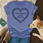 Blue t-shirt with heart-shaped paw prints and "more dogs, less stress" text.