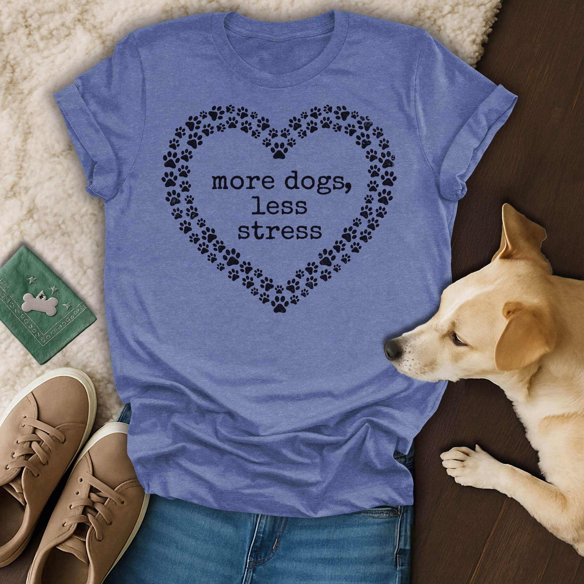 Blue t-shirt with heart-shaped paw prints and "more dogs, less stress" text.
