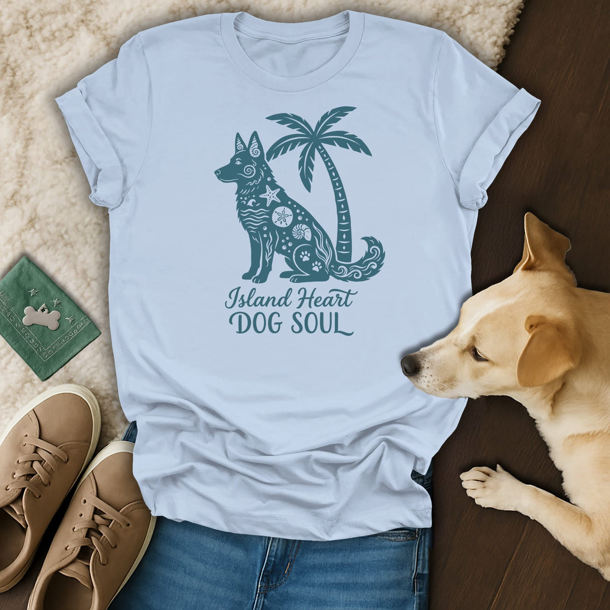 Light blue t-shirt with a dark teal graphic of a dog and palm tree, text "Island Heart DOG SOUL".