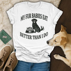 Black dog sits next to a bowl of food, text reads "MY FUR BABIES EAT BETTER THAN I DO".