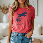 Red graphic t-shirt with black dog jumping over a box, text "All In".
