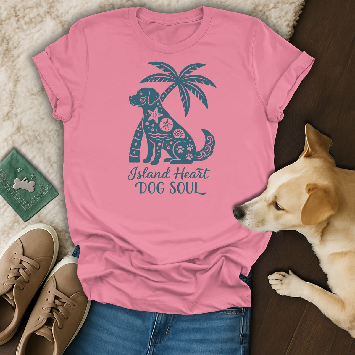 Pink t-shirt with a blue graphic of a dog, palm tree, and text "Island Heart Dog Soul."