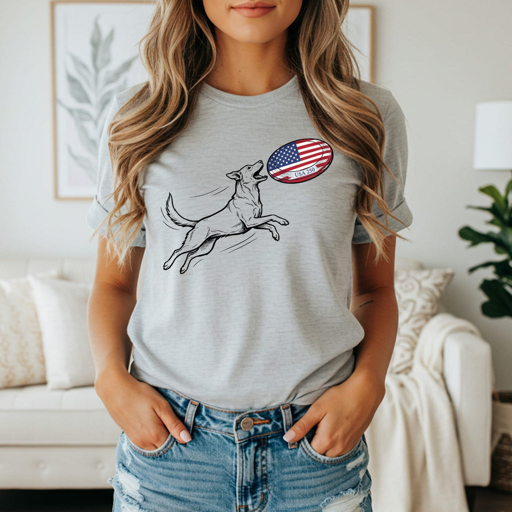 Dog leaping to catch an American flag frisbee on grey t-shirt.