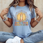 Light blue t-shirt with a dog sitting inside a sun, text reads "FIND YOUR SUNNY SPOT".