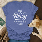 Blue v-neck t-shirt with white text "TALK Furry TO ME" and paw prints.