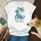 White t-shirt with teal dog, palm tree, and text "Island Heart DOG SOUL".
