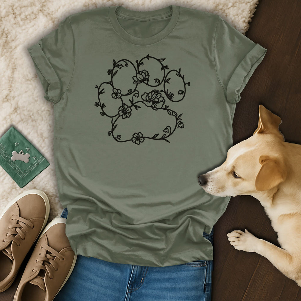 Green t-shirt with floral paw print design, sneakers, and dog.