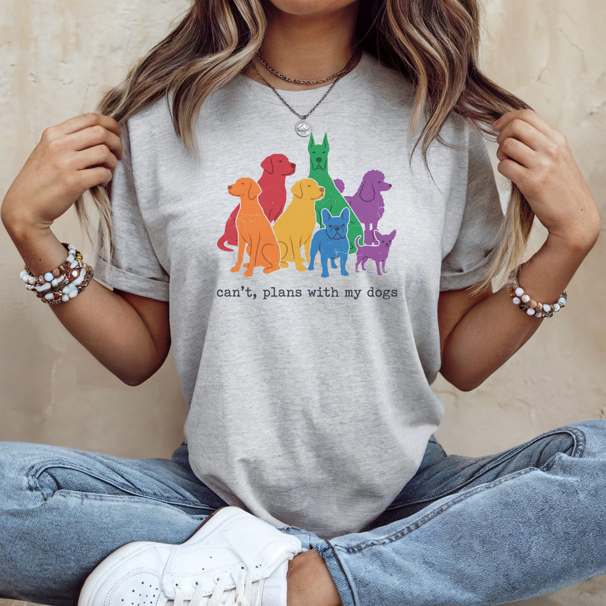 Grey t-shirt with colorful dog silhouettes and text "can't, plans with my dogs."