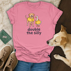 Pink t-shirt with dog and duck illustration and text "double the silly".