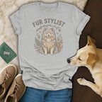 Light grey t-shirt with "Fur Stylist" and a dog illustration, surrounded by flowers and leaves.