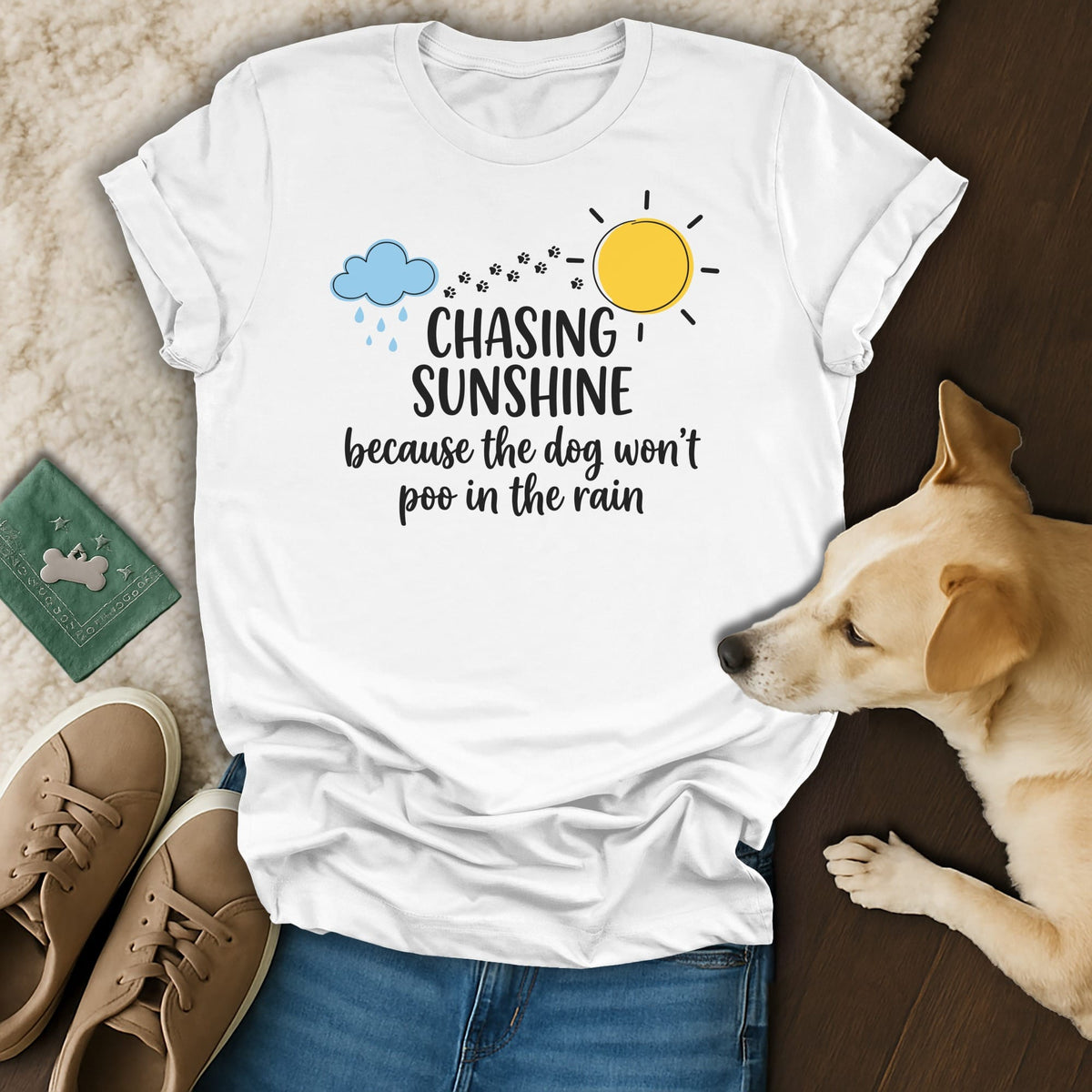 White t-shirt with "Chasing Sunshine because the dog won't poo in the rain" text.