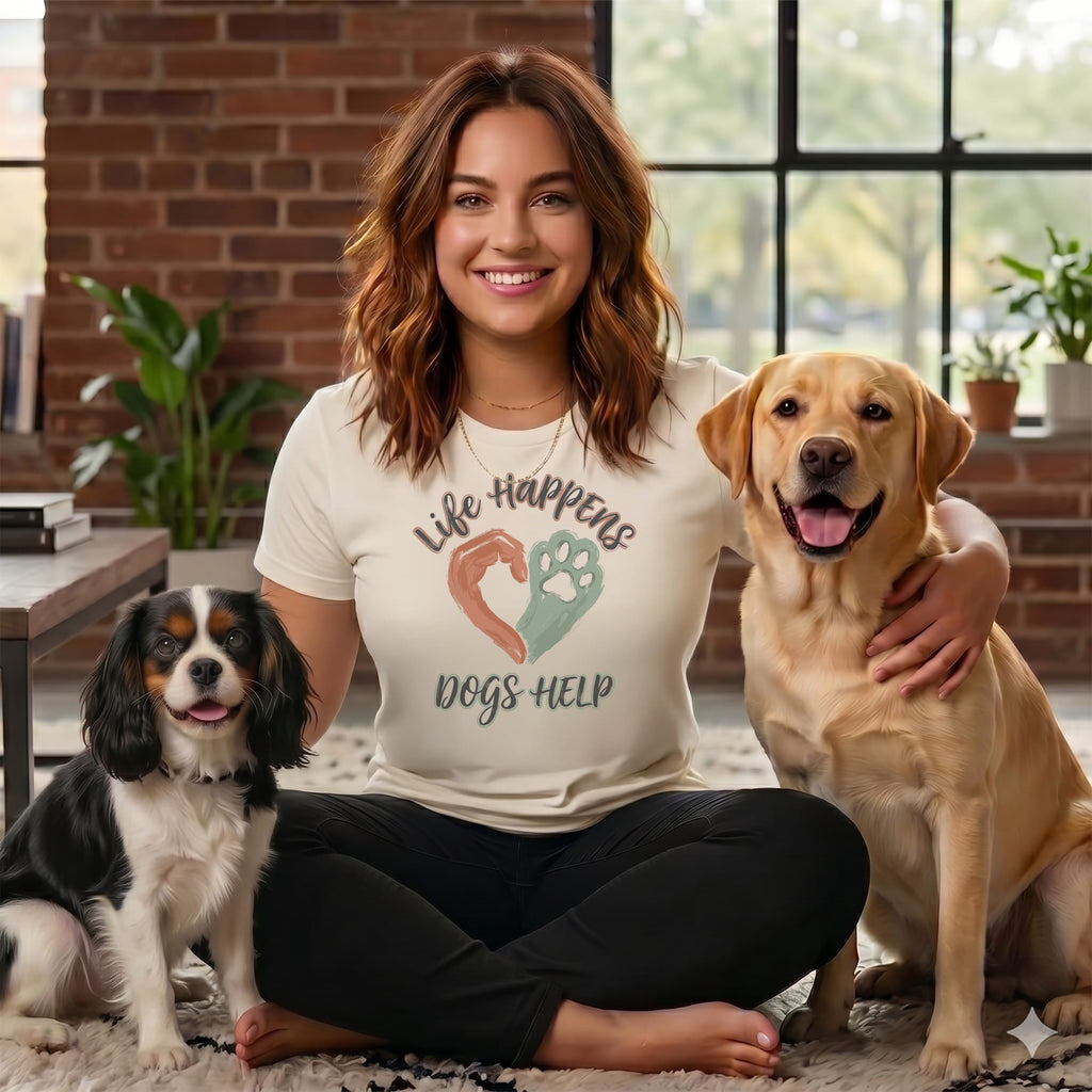 Woman in graphic t-shirt with two dogs, a yellow lab and a King Charles Spaniel.