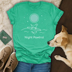 Green t-shirt with "Night Patrol" text and a dog surfing on waves under a moon.