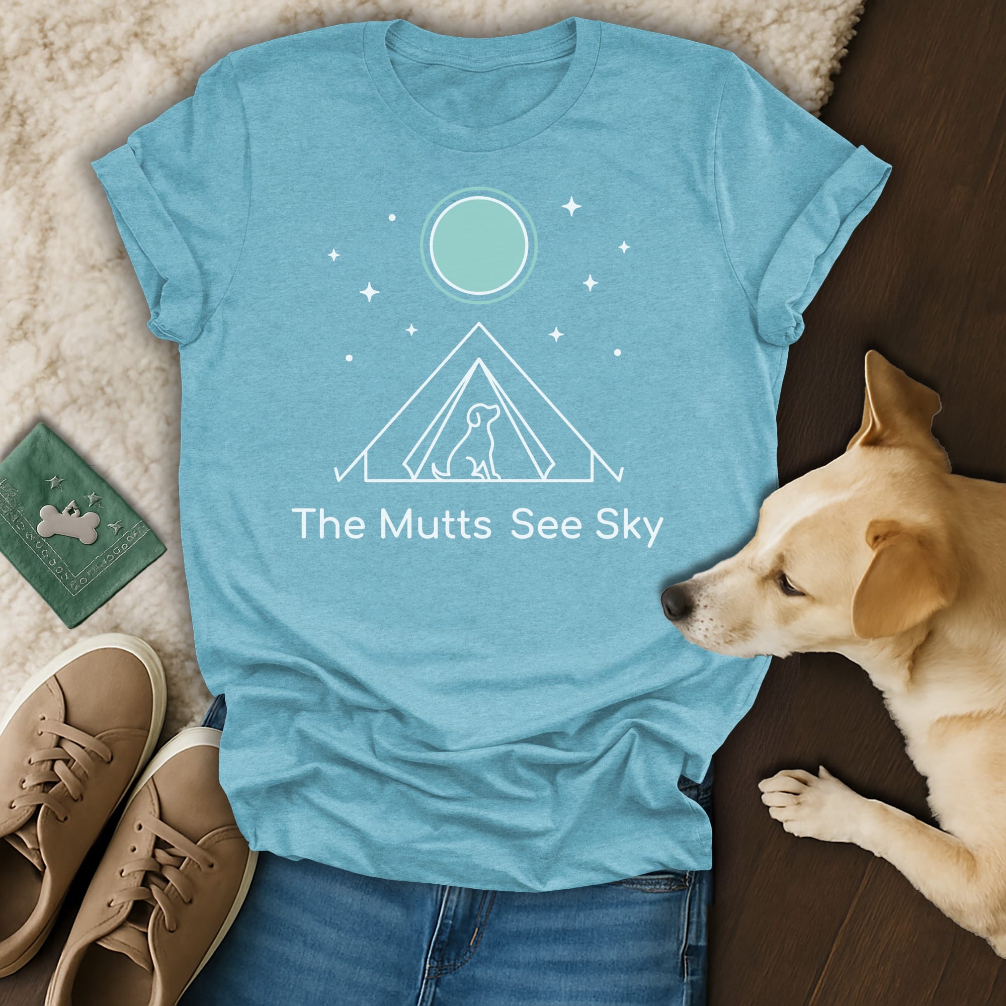 T-shirt with "The Mutts See Sky" text and tent graphic, beside a dog.