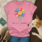 Pink t-shirt with colorful paw print flower and "you are my sunshine" text.