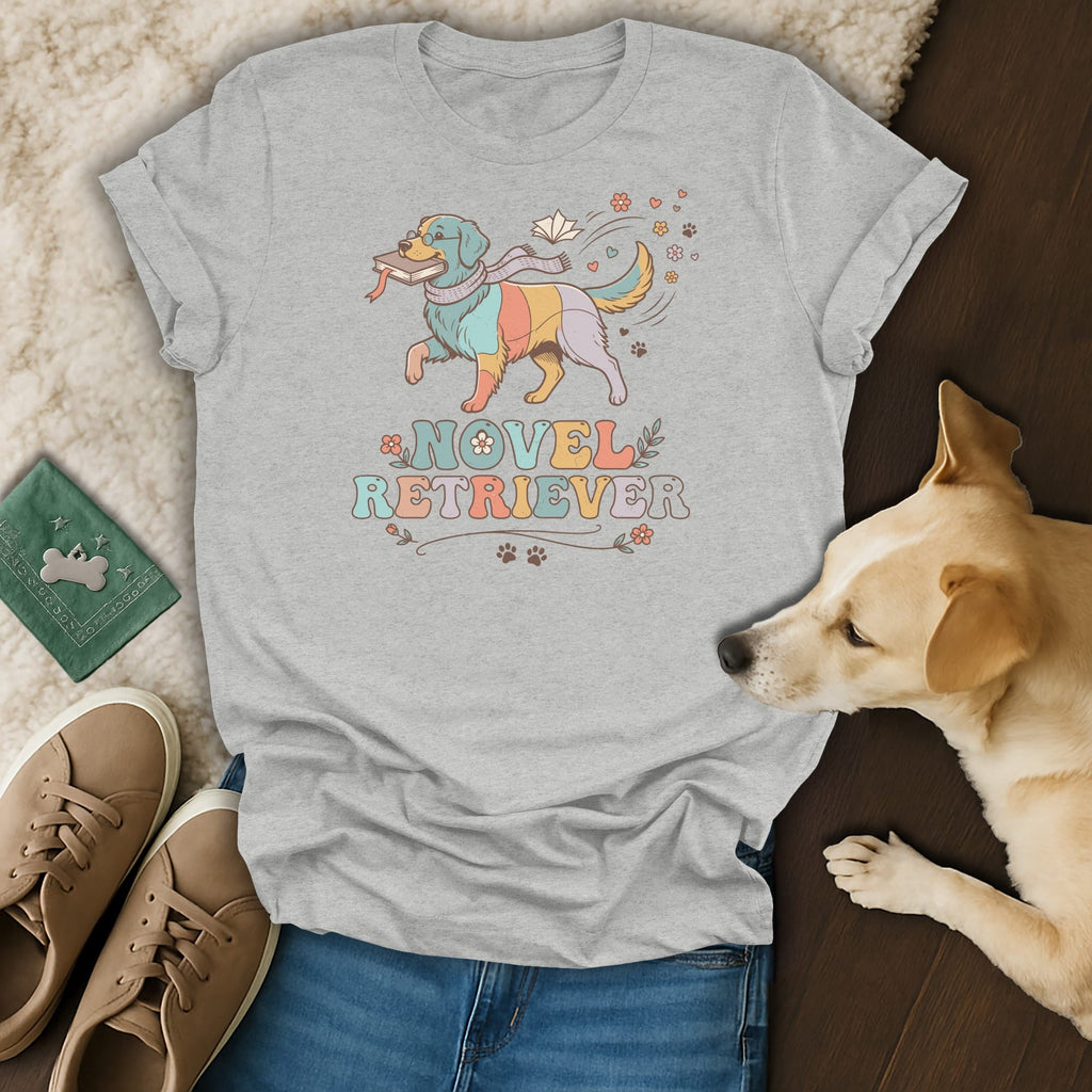 Grey t-shirt graphic with a colorful dog carrying a book and the words "Novel Retriever".
