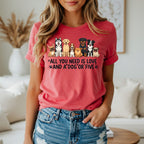 T-shirt with various dog breeds and "All you need is love and a dog or five" text.