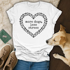 White t-shirt with a heart of paw prints and "more dogs, less stress" text.