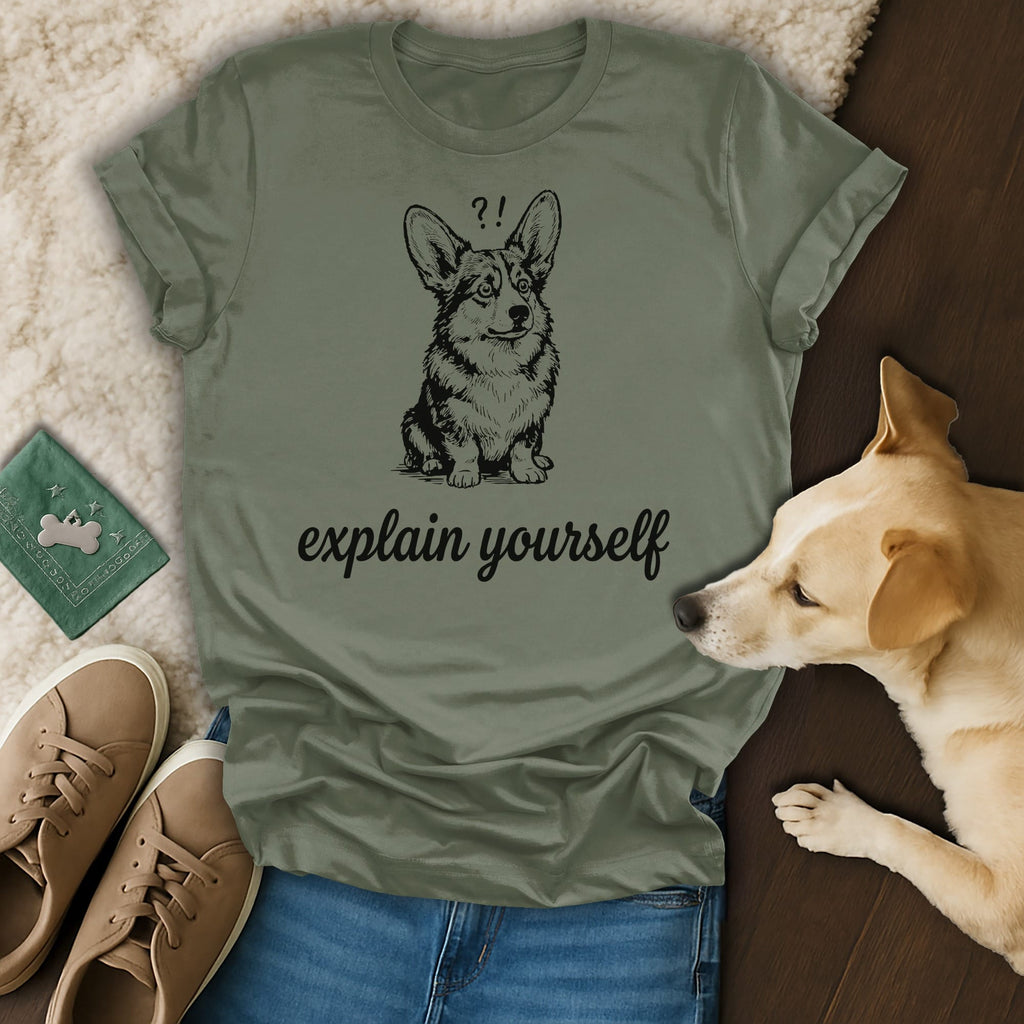Green t-shirt with a corgi illustration and "explain yourself" text.