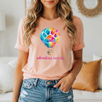 Peach t-shirt with hot air balloon graphic and "adventure awaits" text.