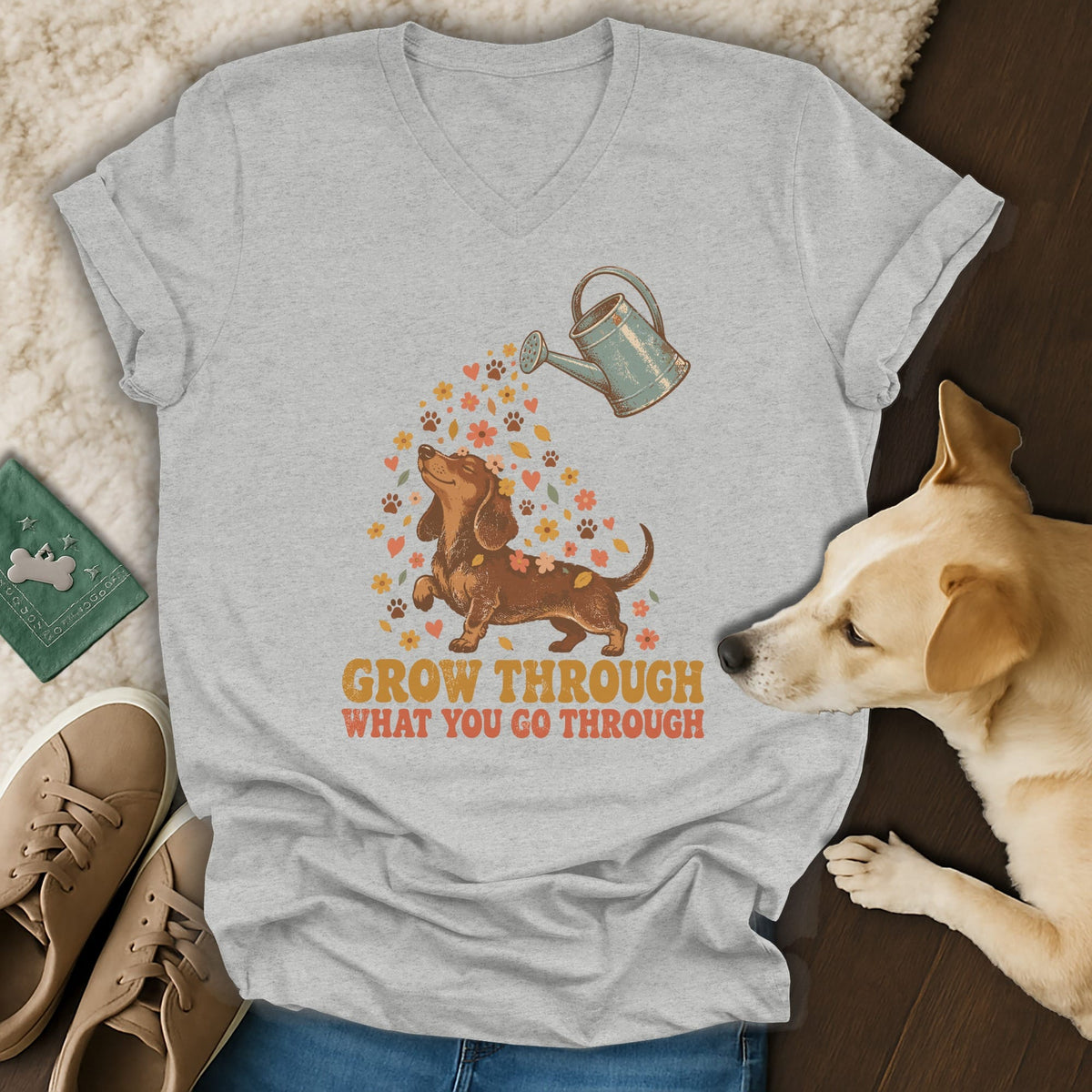 Heather gray v-neck t-shirt featuring a dachshund graphic with text reading GROW THROUGH WHAT YOU GO THROUGH.