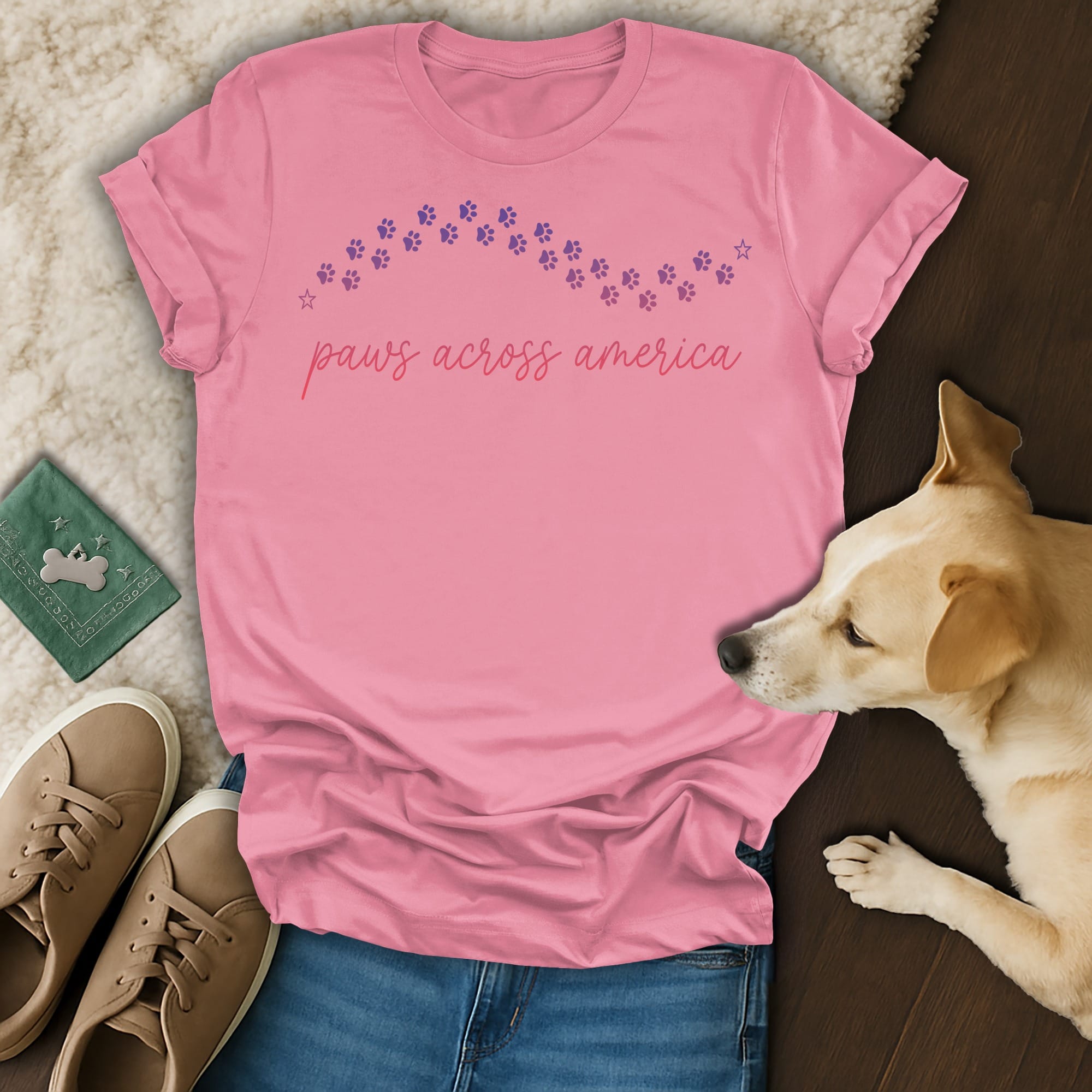 Pink t-shirt with "paws across america" text and paw print graphic.