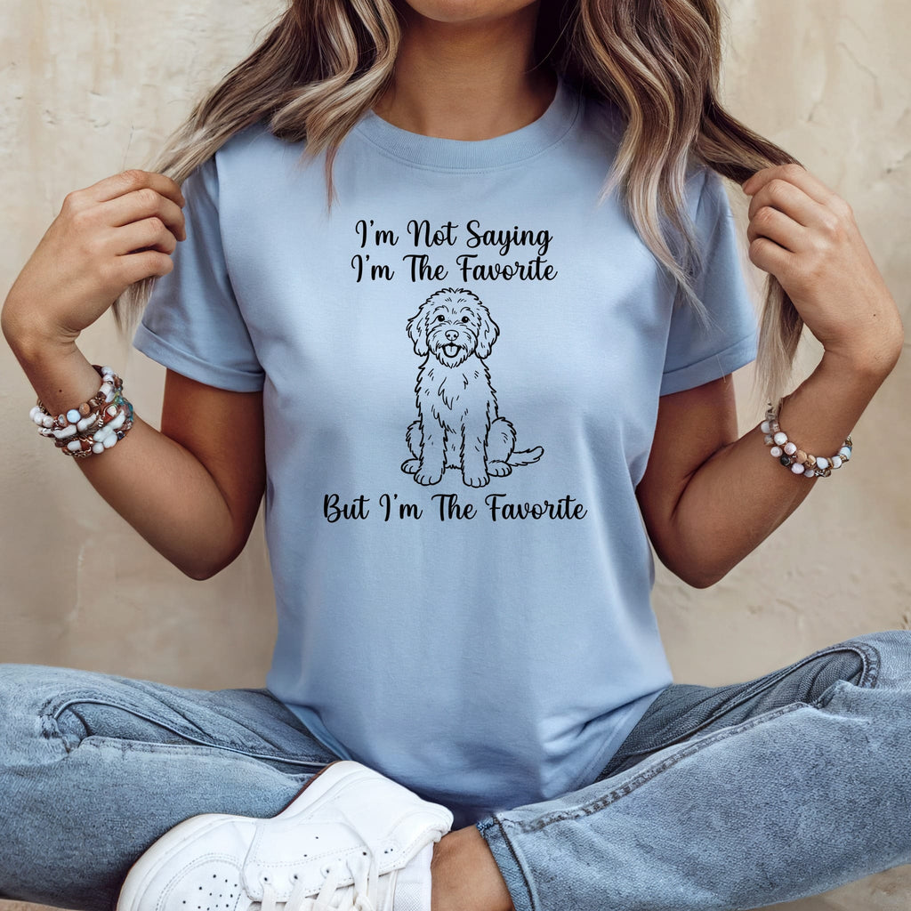 Light blue t-shirt with a doodle dog and "I'm Not Saying I'm The Favorite But I'm The Favorite" text.
