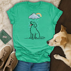 Green t-shirt with a cartoon dog sitting in the rain under a rainbow.