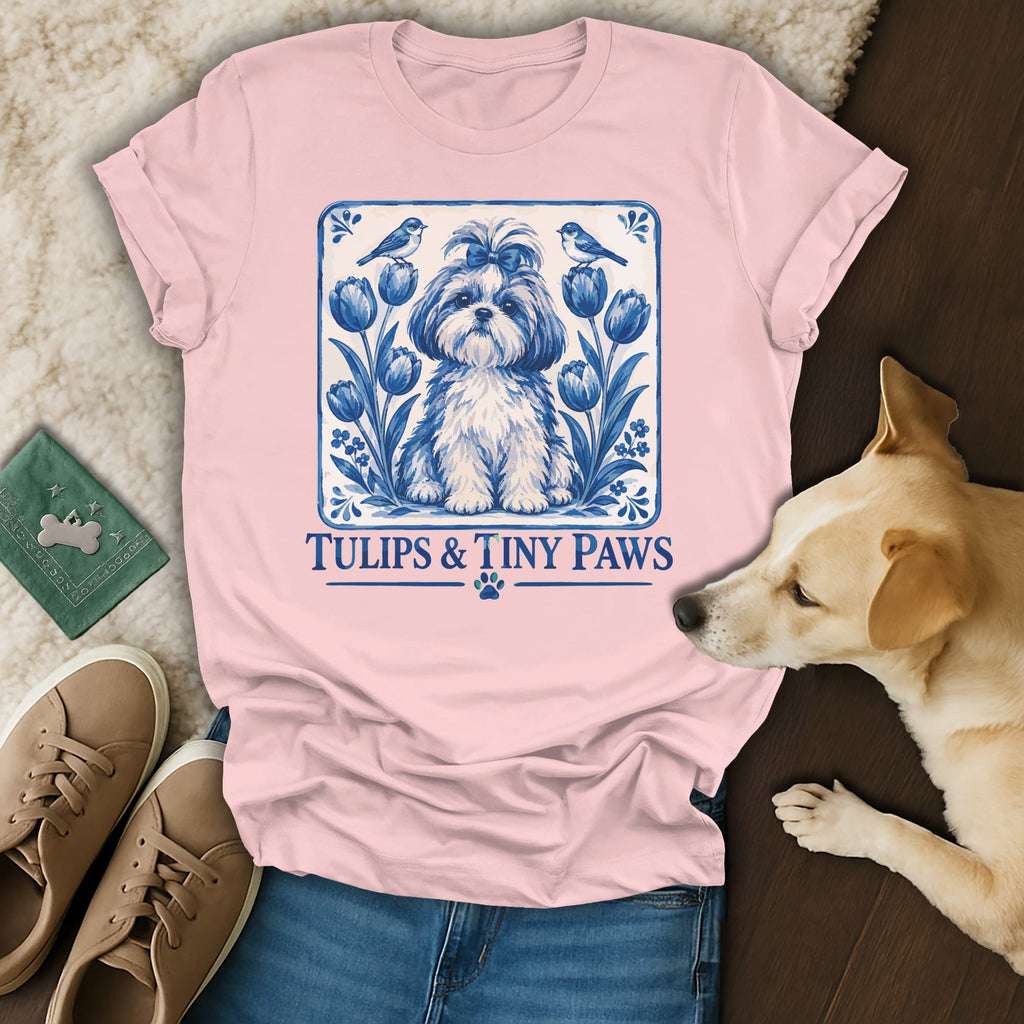 Pink t-shirt with a blue and white graphic of a dog, tulips, and text reading Tulips & Tiny Paws.