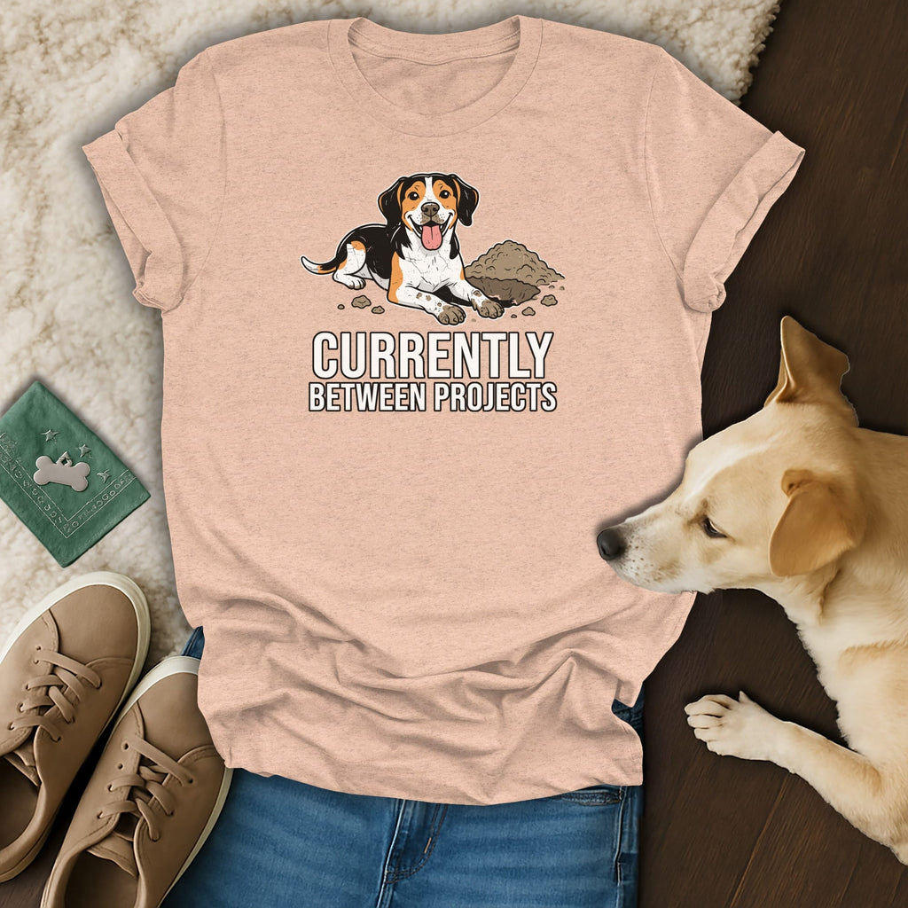 T-shirt with cartoon dog and text "Currently Between Projects".