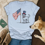 Dog wearing a top hat and bowtie, standing next to an American flag.
