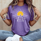 Purple t-shirt with a white graphic of a dog on a pier at sunset.