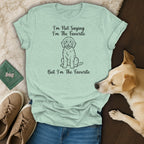 Light green t-shirt with sketch of dog and text "I'm Not Saying I'm The Favorite But I'm The Favorite".