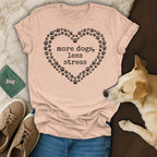 Peach t-shirt with heart of paw prints and text "more dogs, less stress".