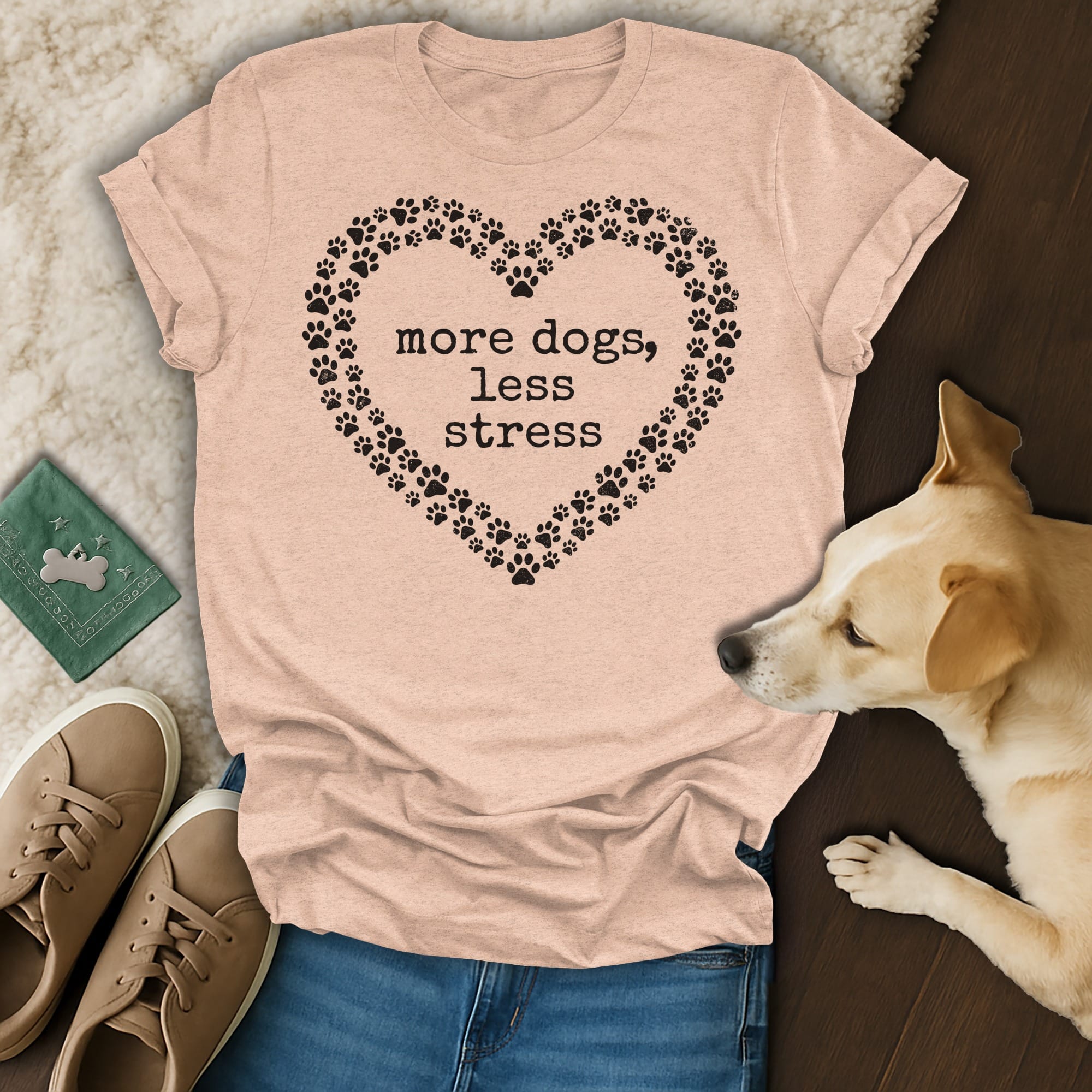 Peach t-shirt with heart of paw prints and text "more dogs, less stress".