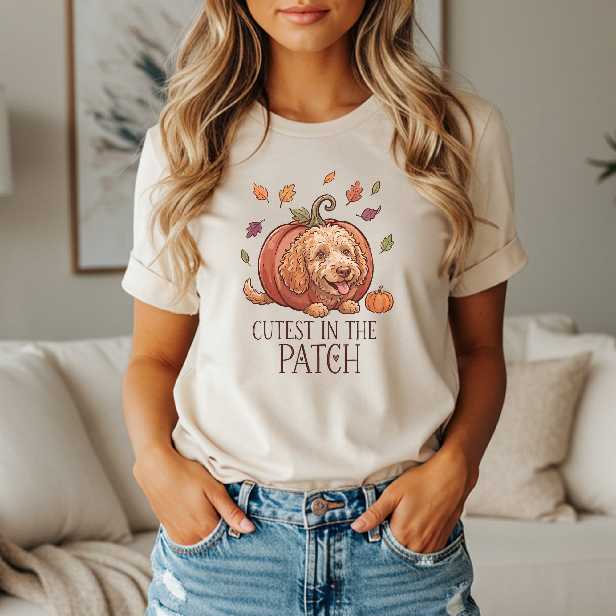Dog peeking from pumpkin with text "Cutest in the Patch" and falling leaves.