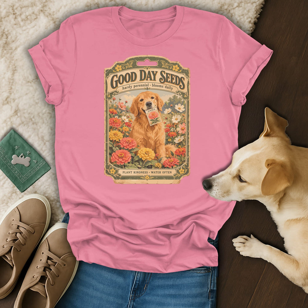 Pink t-shirt with a vintage seed packet graphic featuring a golden retriever surrounded by flowers.
