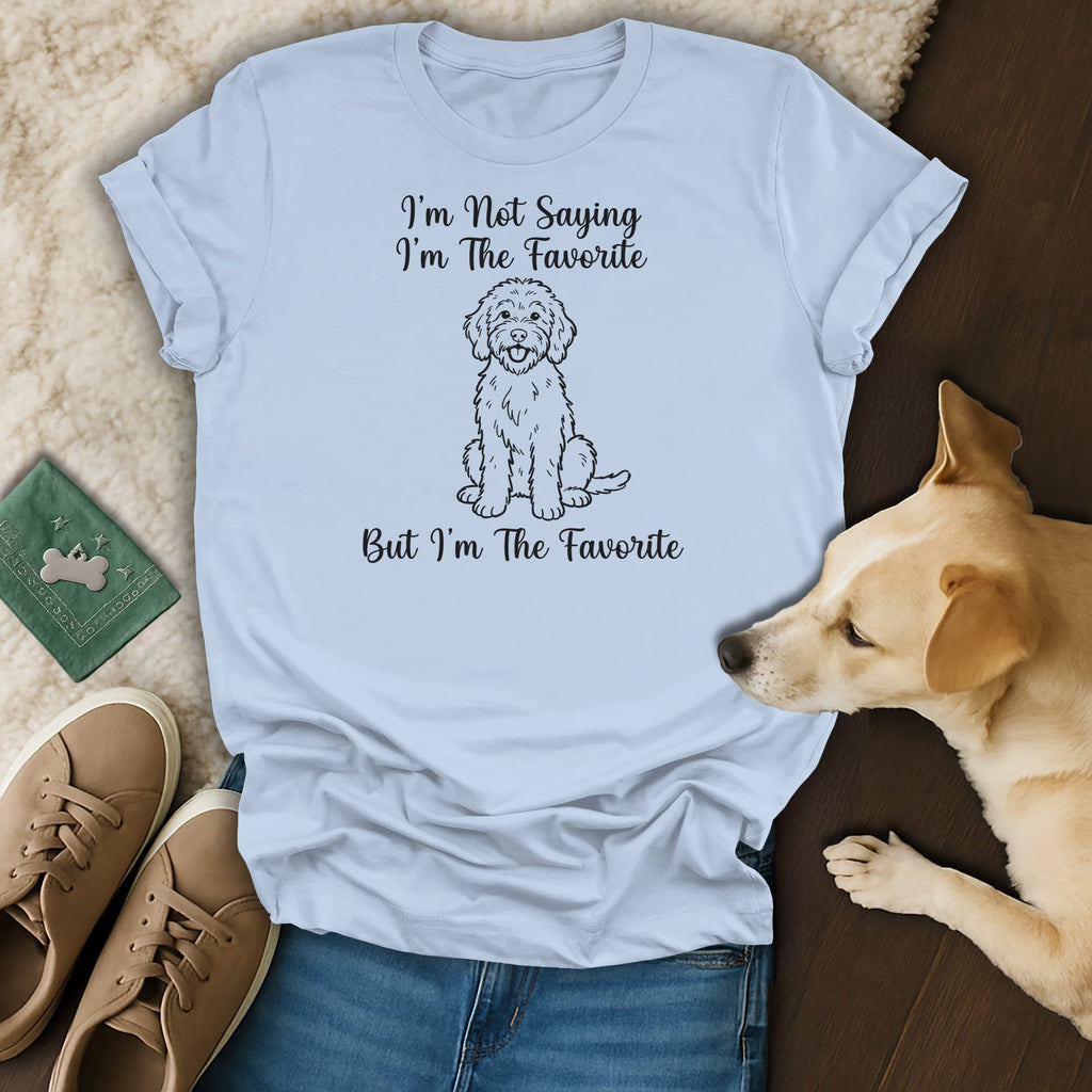 Light blue t-shirt with a doodle dog graphic and text "I'm Not Saying I'm The Favorite But I'm The Favorite."