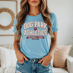 Light blue t-shirt with "Dog Park Athletics" and "Professionally Trained (By My Dog)" text.