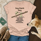 Pink t-shirt with "Dog Park Day" text and stick-carrying dog illustration.