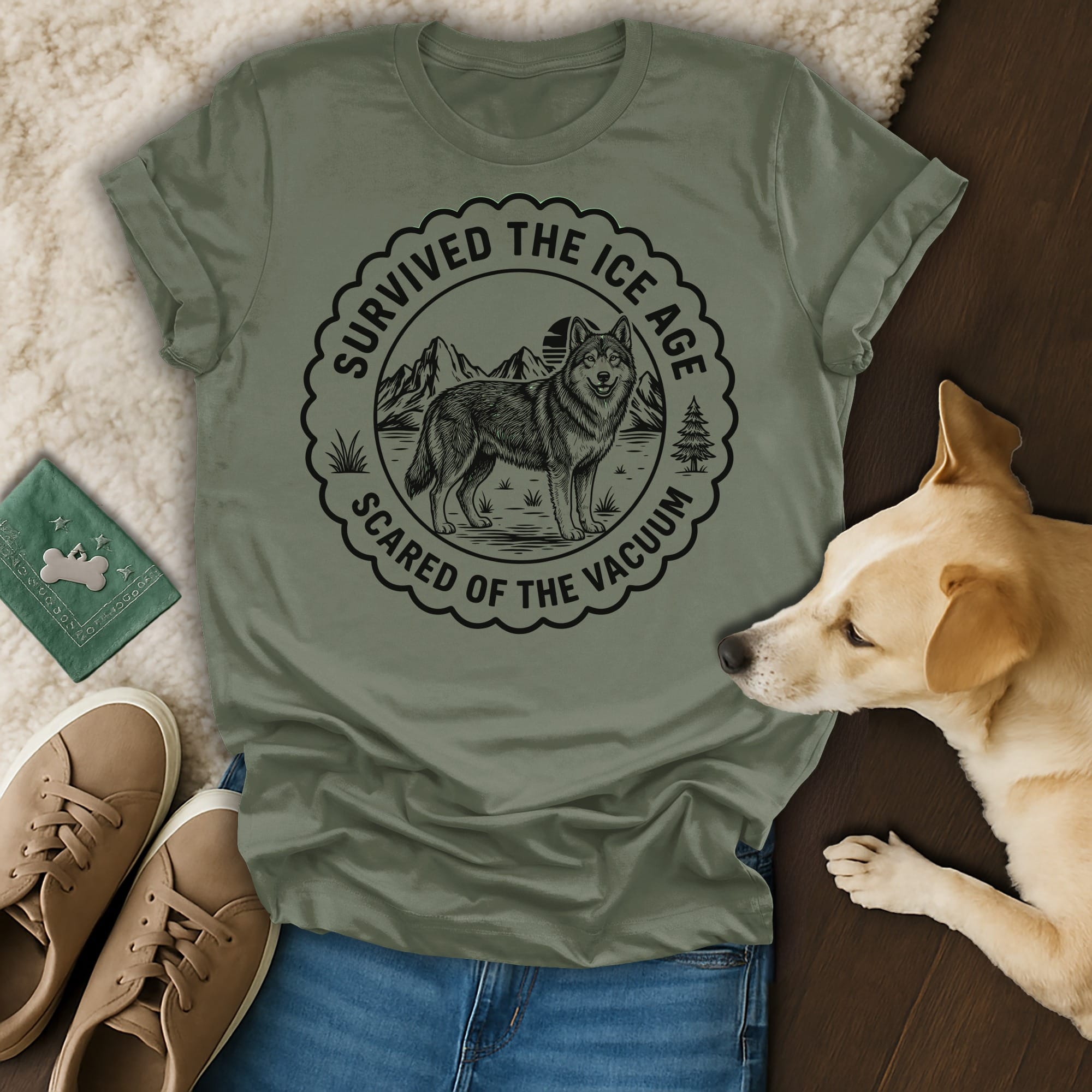Olive green t-shirt with "Survived the Ice Age Scared of the Vacuum" text and wolf graphic.