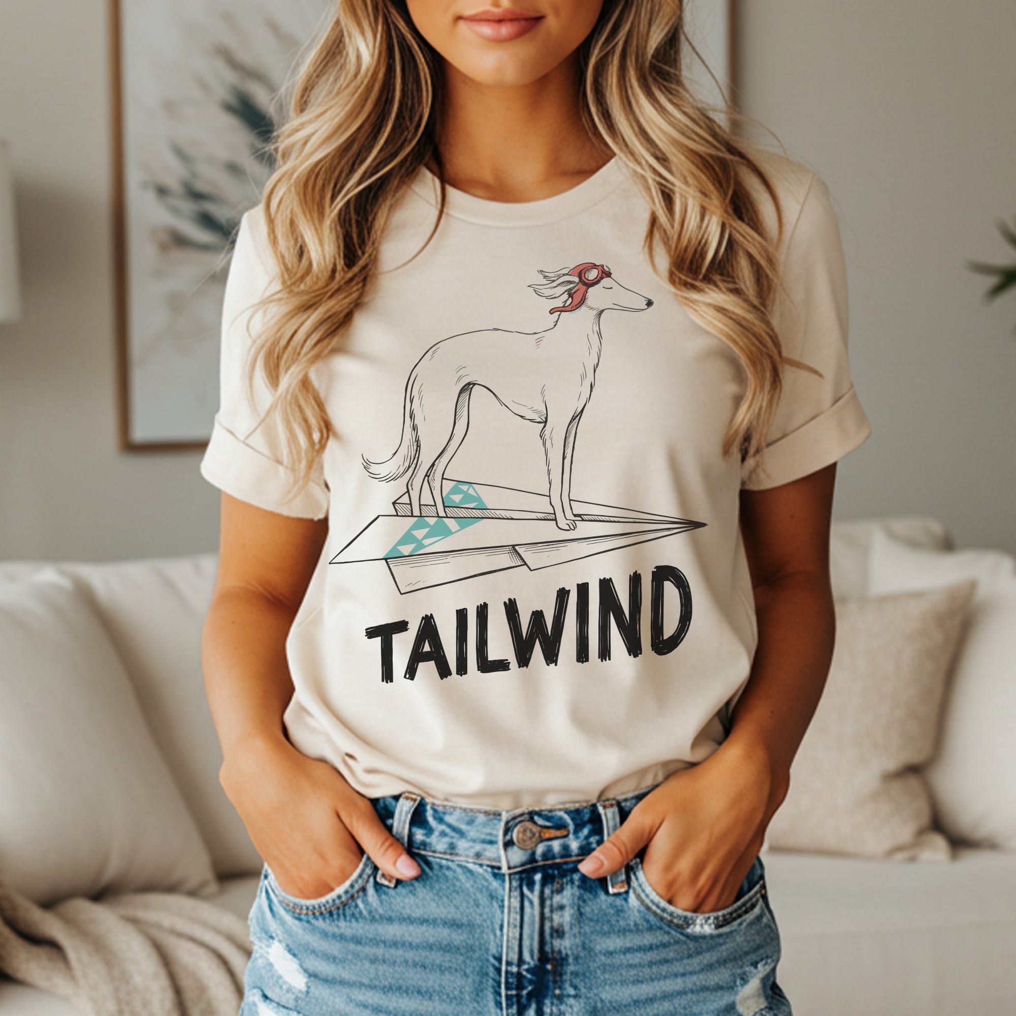 Cream t-shirt with a line drawing of a dog on a paper airplane.