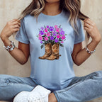 Light blue t-shirt with cowboy boots and colorful paw print floral arrangement.