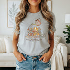 T-shirt graphic with dog, flowers, and text: GROW THROUGH IT WITH A DOG BESIDE YOU.