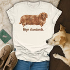 Cream t-shirt with brown dachshund illustration and text "High standards."