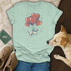 Light green t-shirt with cartoon dachshund floating with heart balloons.